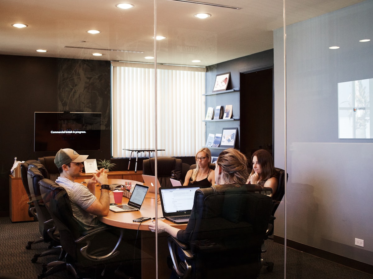 Business professionals meeting around a laptop