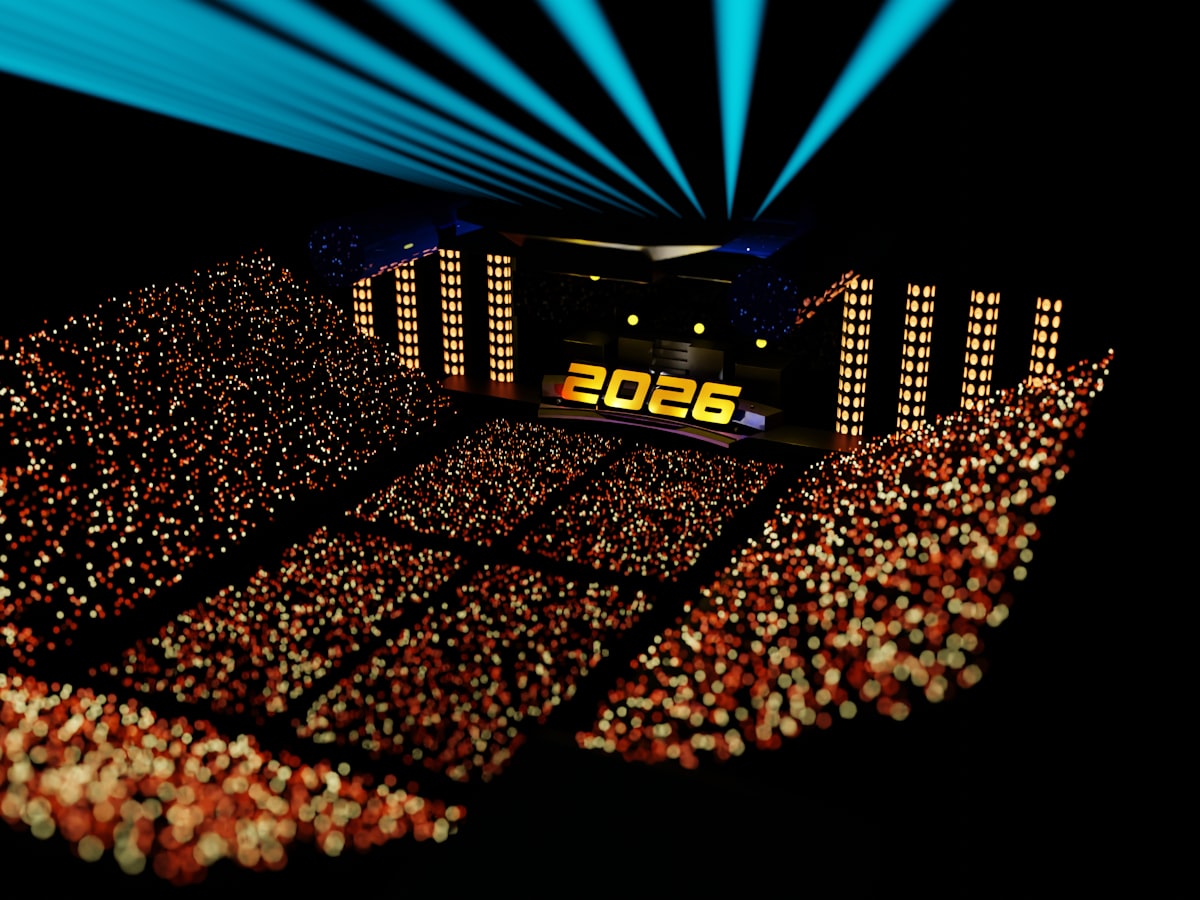 A crowd watches an illuminated concert stage